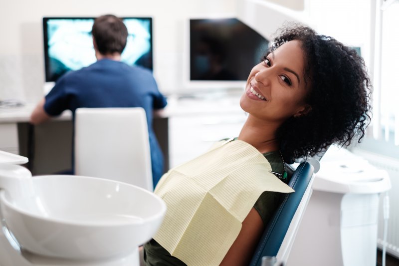 A young woman sitting back in the dentist’s chair and waiting to see the dentist for her checkup